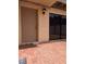 Beige home exterior featuring an exterior door, brick patio, and a large window at 8114 Oak Trace Way # D, Tampa, FL 33634