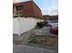 Townhouse with a white fence, red brick walk way, dark windows and parking at 8114 Oak Trace Way # D, Tampa, FL 33634