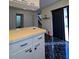 Open kitchen with white cabinets, black tile floors, and direct access to backyard at 8114 Oak Trace Way # D, Tampa, FL 33634