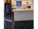 The kitchen includes a refrigerator, white cabinets, and a peninsula counter at 8114 Oak Trace Way # D, Tampa, FL 33634