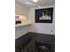 Kitchen with black marble flooring, white counters, and a modern black and white art piece at 8114 Oak Trace Way # D, Tampa, FL 33634