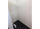 This laundry room features black marble style floors, white walls, and a single wire shelf at 8114 Oak Trace Way # D, Tampa, FL 33634