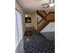 Living room with black marble floor, staircase, and white door at 8114 Oak Trace Way # D, Tampa, FL 33634