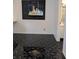 Living room featuring black marble flooring, artwork, and a doorway leading to the bathroom at 8114 Oak Trace Way # D, Tampa, FL 33634