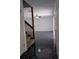 Living room with black marble flooring leading to a carpeted staircase and white door at 8114 Oak Trace Way # D, Tampa, FL 33634
