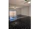 Living room featuring a black marble floor, mirrored wall, and sliding door access to the outside at 8114 Oak Trace Way # D, Tampa, FL 33634