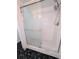 Bathroom shower with white tile and a glass enclosure at 8114 Oak Trace Way # D, Tampa, FL 33634