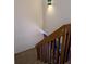 Carpeted staircase with wood railings leads to the upper level of this home at 8114 Oak Trace Way # D, Tampa, FL 33634
