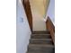 Carpeted staircase with wood railings leads to the upper level of this home at 8114 Oak Trace Way # D, Tampa, FL 33634