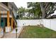 Back yard with a stone pathway, white fence, and staircase leading to the upper level at 854 77Th N Ave, St Petersburg, FL 33702
