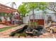 Landscaped backyard featuring an outdoor brick oven and pond with a small stone waterfall at 854 77Th N Ave, St Petersburg, FL 33702