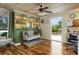 Cozy den with built-in shelving, ceiling fan, and access to a deck with outdoor seating at 854 77Th N Ave, St Petersburg, FL 33702