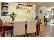 Inviting dining area with a wooden table, comfortable seating, and stylish lighting fixture at 854 77Th N Ave, St Petersburg, FL 33702