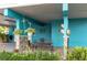 Cozy, covered outdoor space with an iron bench, hanging plants, and decorative accents at 854 77Th N Ave, St Petersburg, FL 33702