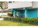 Exterior of a two-story home with car port and colorful facade and landscaping at 854 77Th N Ave, St Petersburg, FL 33702