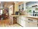 Bright kitchen featuring butcher block countertops, white cabinets, and stainless steel appliances at 854 77Th N Ave, St Petersburg, FL 33702