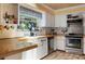 Charming kitchen featuring wooden countertops, stainless steel appliances, and a bright, airy feel at 854 77Th N Ave, St Petersburg, FL 33702