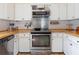 Updated kitchen with stainless steel appliances, butcher block countertops, and ample cabinet space at 854 77Th N Ave, St Petersburg, FL 33702