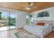 Tranquil main bedroom with sliding glass doors to deck and wood ceilings at 854 77Th N Ave, St Petersburg, FL 33702