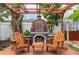 Inviting outdoor fireplace area with wooden chairs on a wooden deck, perfect for relaxing at 854 77Th N Ave, St Petersburg, FL 33702