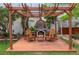 Charming backyard pergola area features brick pizza oven and wood-burning stove at 854 77Th N Ave, St Petersburg, FL 33702