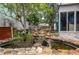 Backyard features a rock waterfall flowing into a pond with lush landscaping at 854 77Th N Ave, St Petersburg, FL 33702