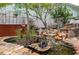 Backyard features a rock waterfall flowing into a pond with lush landscaping at 854 77Th N Ave, St Petersburg, FL 33702