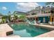 Inviting backyard pool area featuring brick coping, lounge chairs, and outdoor grilling and seating at 854 77Th N Ave, St Petersburg, FL 33702