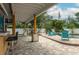Charming backyard with a pool, covered patio, poolside bar, and comfortable seating, ideal for outdoor enjoyment at 854 77Th N Ave, St Petersburg, FL 33702