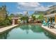 Backyard pool featuring an outdoor kitchen, an upstairs balcony, and several Adirondack chairs for entertaining at 854 77Th N Ave, St Petersburg, FL 33702
