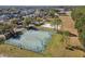 Aerial view of a basketball court and sand volleyball court in a community park setting at 8736 Huntfield St, Tampa, FL 33635