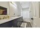 Bathroom offers marble countertops, a shower, and stylish wood-look floors at 8736 Huntfield St, Tampa, FL 33635