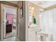 Bathroom with vanity and shower/tub combination, accessible from the hallway and bedroom at 8736 Huntfield St, Tampa, FL 33635