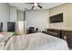 Comfortable bedroom features a ceiling fan and a TV for relaxation and entertainment at 8736 Huntfield St, Tampa, FL 33635