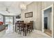 Charming dining room with a wooden table and chairs, illuminated by a stylish chandelier at 8736 Huntfield St, Tampa, FL 33635
