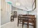 Bright dining area featuring a table for six, decorative lighting, and modern tiled flooring at 8736 Huntfield St, Tampa, FL 33635