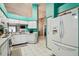 A kitchen shows a stainless steel appliances, white cabinets, and tile flooring at 8736 Huntfield St, Tampa, FL 33635