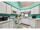 Kitchen features white cabinets, stainless steel appliances, and tile flooring at 8736 Huntfield St, Tampa, FL 33635