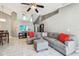 Spacious living room featuring a comfortable gray sectional sofa and large, light-filled windows at 8736 Huntfield St, Tampa, FL 33635