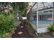 Lush landscaping with pathway leading to the screened in pool at 8740 15Th N St, St Petersburg, FL 33702