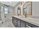 Bathroom featuring double vanity, marble-style walls, and white marble floors at 8740 15Th N St, St Petersburg, FL 33702