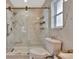 Bathroom featuring marble-style tiling and walk-in shower with bronze hardware at 8740 15Th N St, St Petersburg, FL 33702