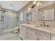 Bathroom featuring marble-style tiling, double vanity and walk-in shower at 8740 15Th N St, St Petersburg, FL 33702