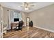 Bedroom featuring a desk, ceiling fan and wood-style tile floors at 8740 15Th N St, St Petersburg, FL 33702