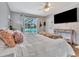 Comfortable bedroom featuring a queen-size bed and sliding glass doors opening to the pool area at 8740 15Th N St, St Petersburg, FL 33702