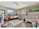 Bright bedroom with hardwood floors, two windows, and a ceiling fan at 8740 15Th N St, St Petersburg, FL 33702