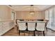 Dining room features a dark wood table, cushioned chairs and a built-in cabinet at 8740 15Th N St, St Petersburg, FL 33702