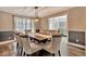 Dining room features a dark wood table, cushioned chairs and modern light fixture at 8740 15Th N St, St Petersburg, FL 33702