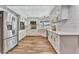 Bright kitchen with white cabinets, stainless steel appliances, and wood floors at 8740 15Th N St, St Petersburg, FL 33702