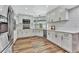 Bright kitchen with white cabinets, stainless steel appliances, and wood floors at 8740 15Th N St, St Petersburg, FL 33702